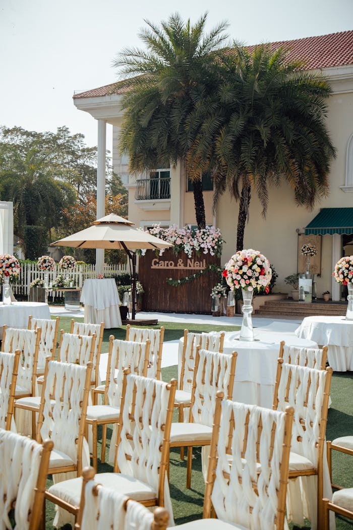 services-03 An elegant outdoor wedding setup with chairs, flowers, and decorations.