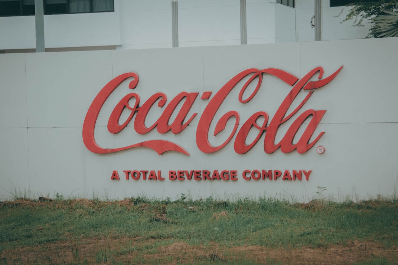 services-01 Image of Coca-Cola logo on outdoor signage, showing brand identity.